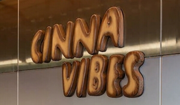 Cinnavibes A wall sign with the words “CINNA VIBES” in large, stylised brown letters resembling cinnamon rolls—a perfect centrepiece for any Cinnamon Desserts Café or Cinnavibes-themed space. Cinnamon Rolls