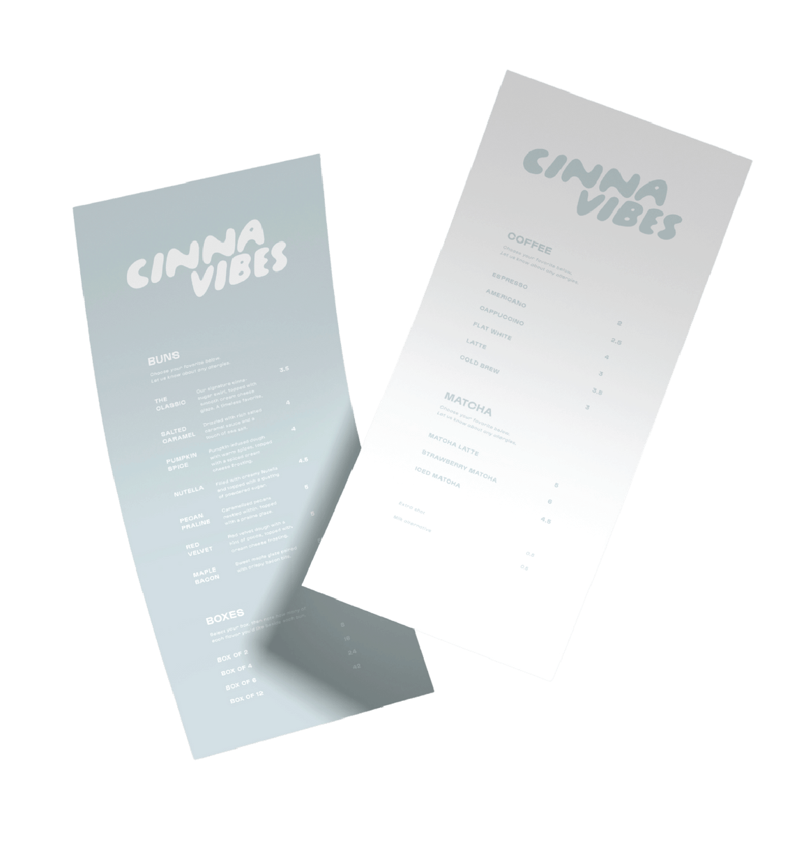 Cinnavibes Two Cinna Vibes menus displayed on a white surface, listing blends, boxes, coffee, and matcha options with prices in a minimalist design—perfectly capturing the inviting atmosphere of CinnaVibes, your go-to Cinnamon Desserts Café. Cinnamon Rolls